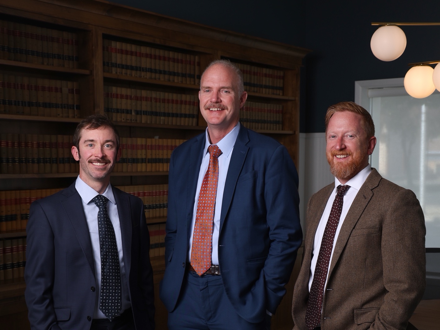 The attorneys of Baum Smith LLC in the library at 808 Adams Avenue