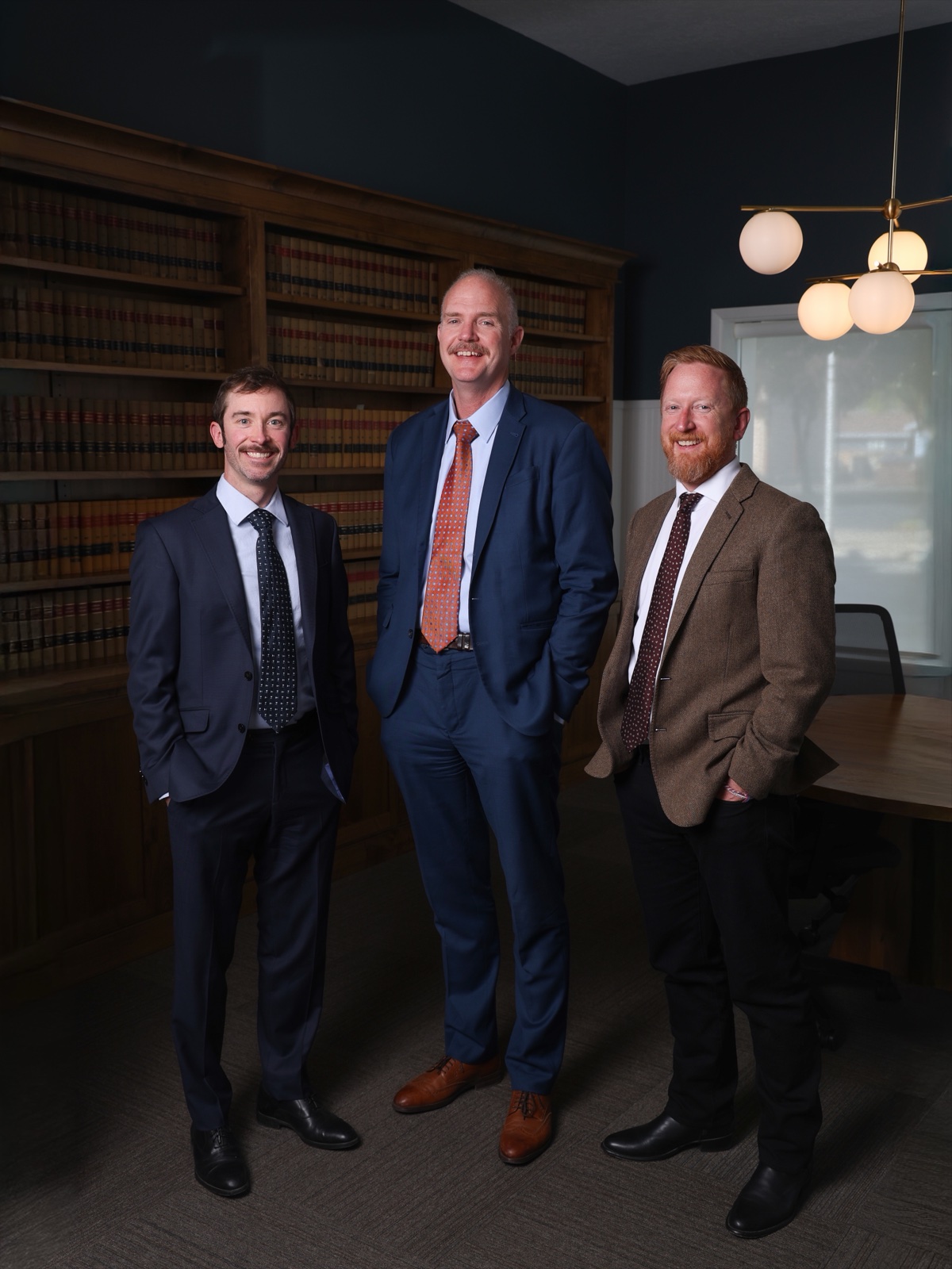 The attorneys of Baum Smith LLC in the library at 808 Adams Avenue